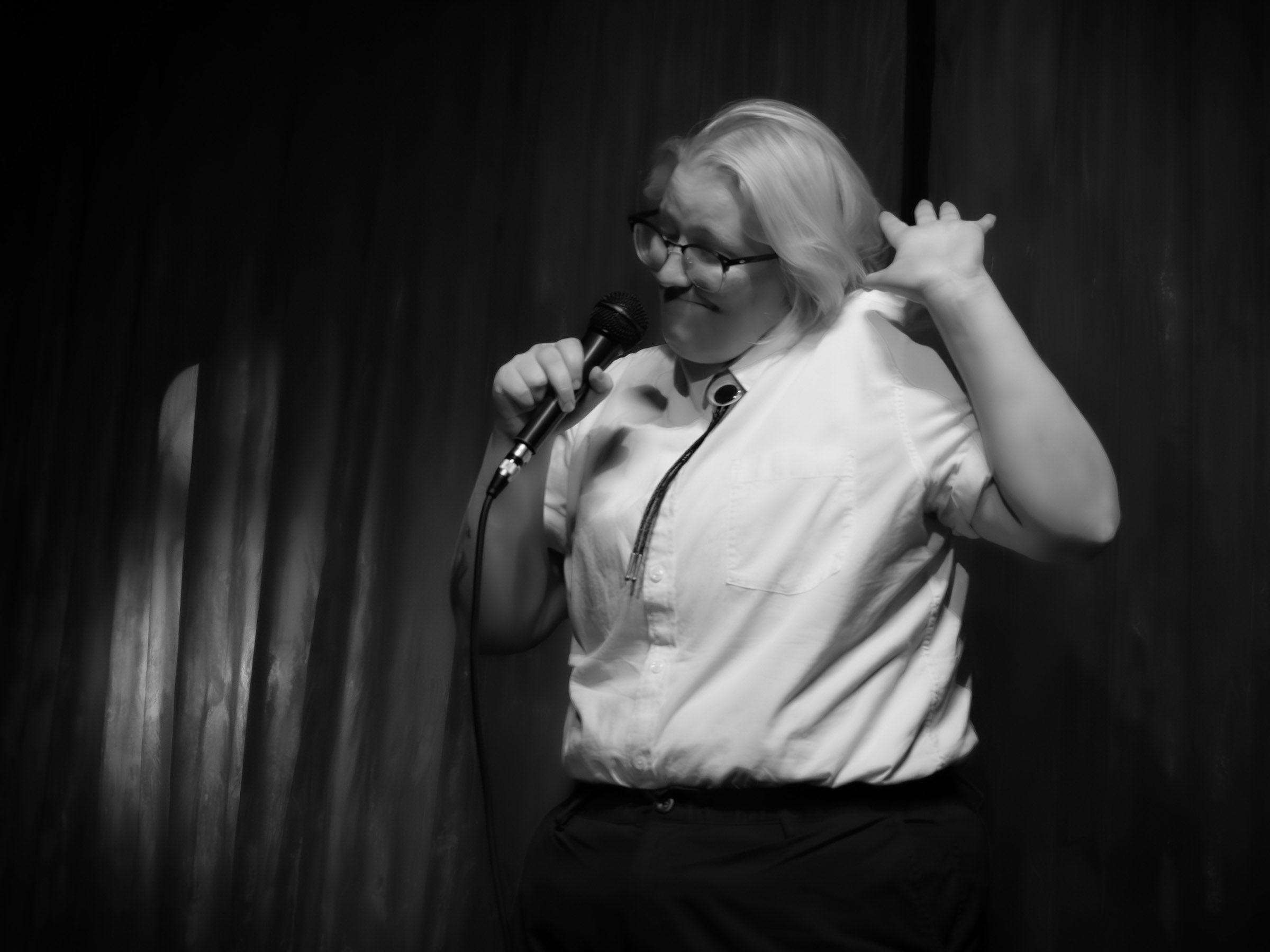 Comedian Ellie Boroughs throws up their hands.