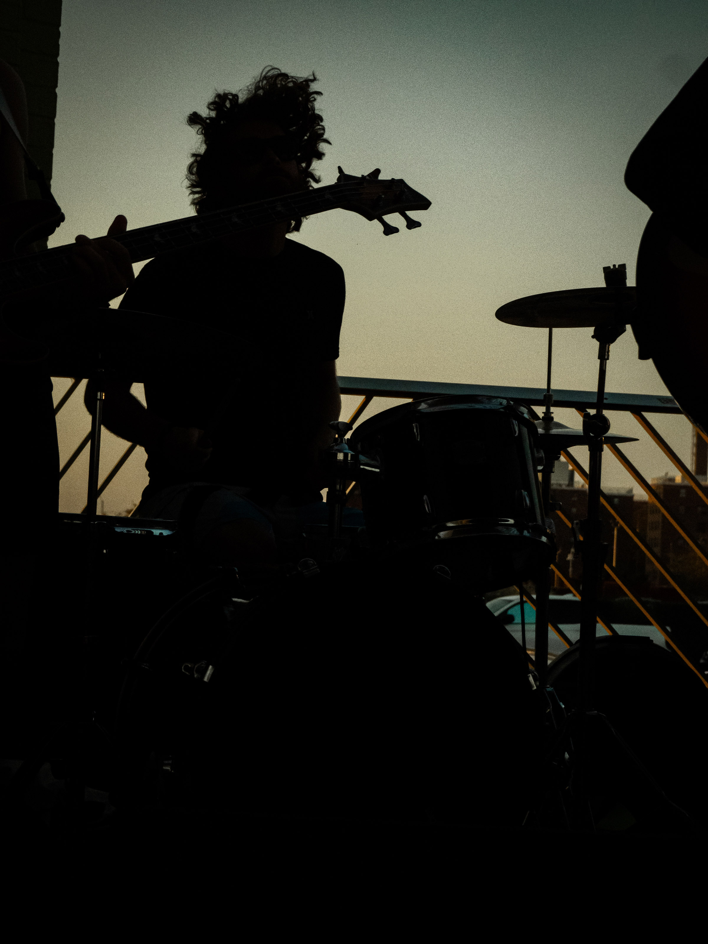 Brendan's sillouette against the sunset as he drums.